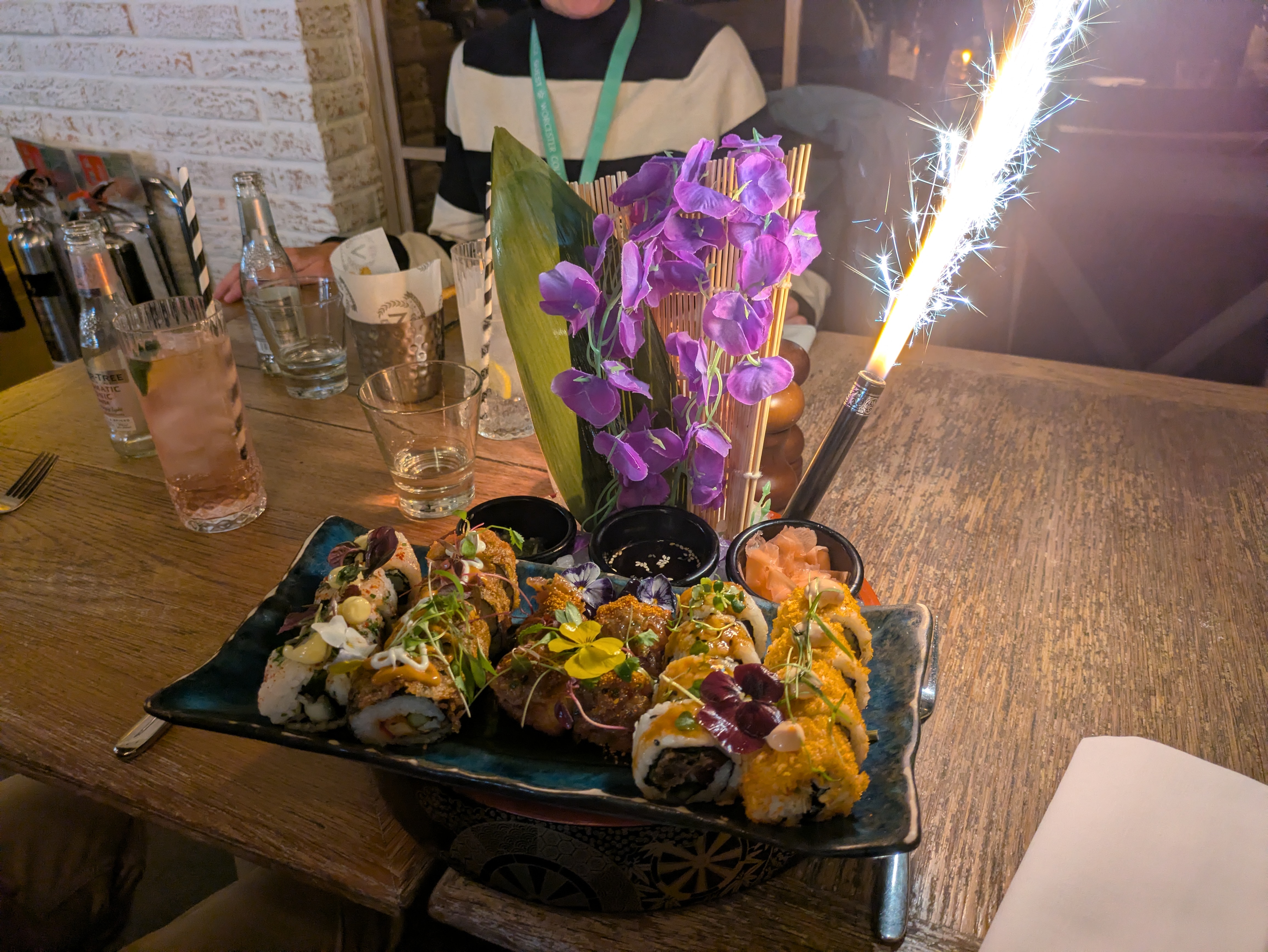 A plate of sushi with a sparkler