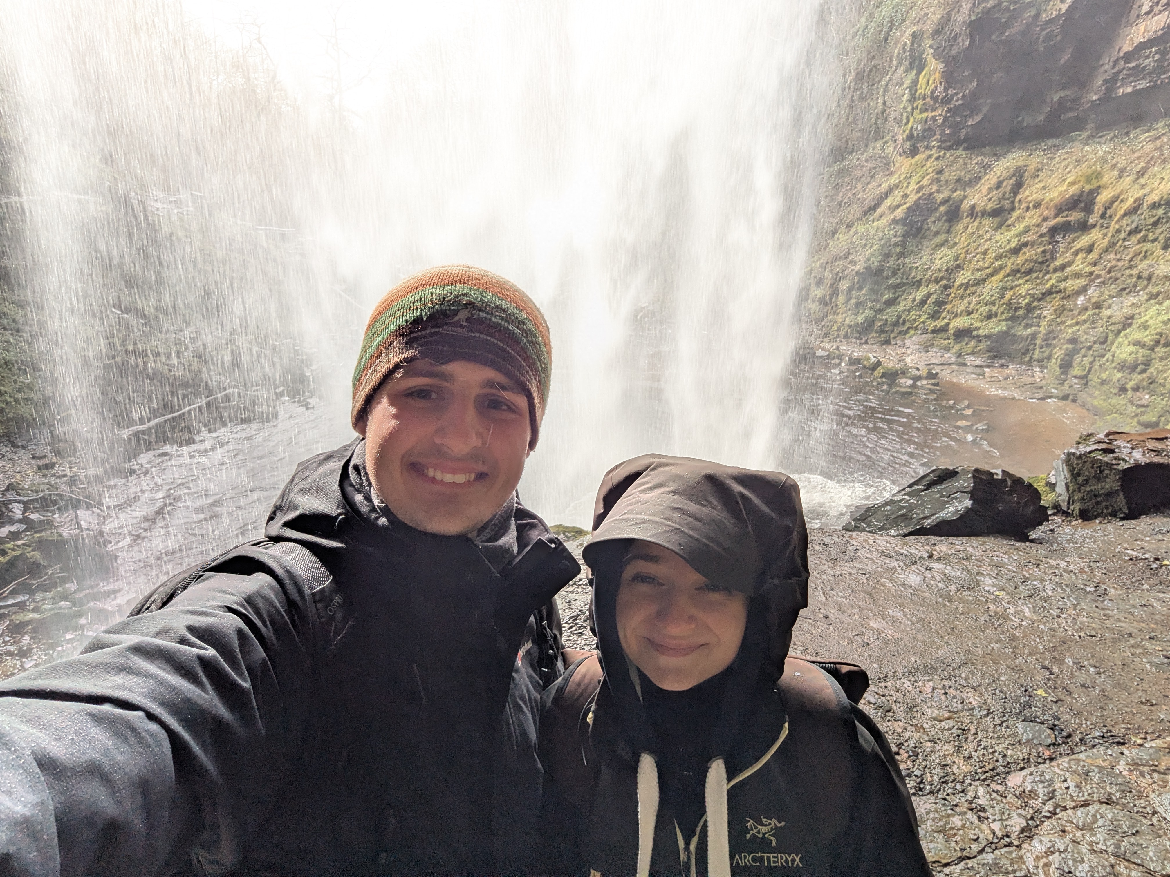 A photo of Leo and Grace behind Henrhyd Falls