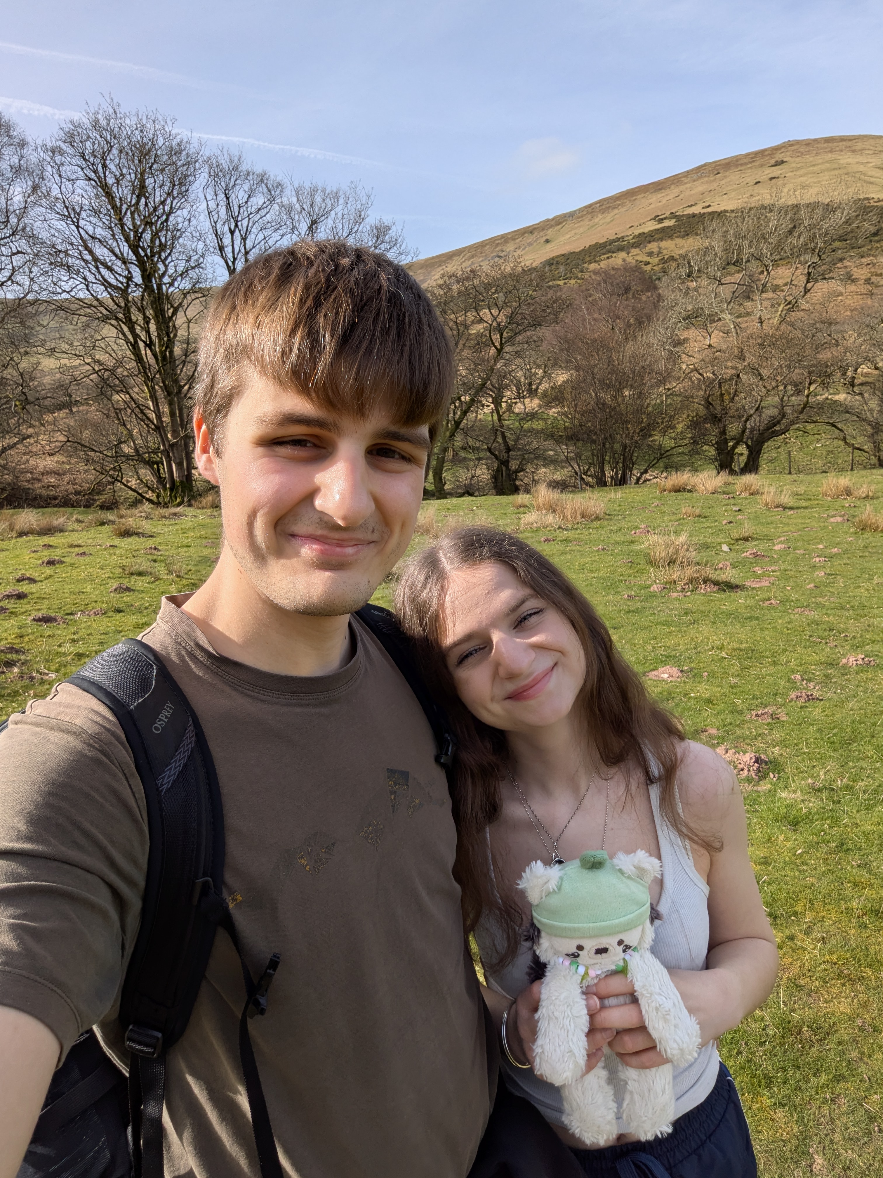 A photo of Leo, Grace and Pom (hedgehog plushie) in the sun